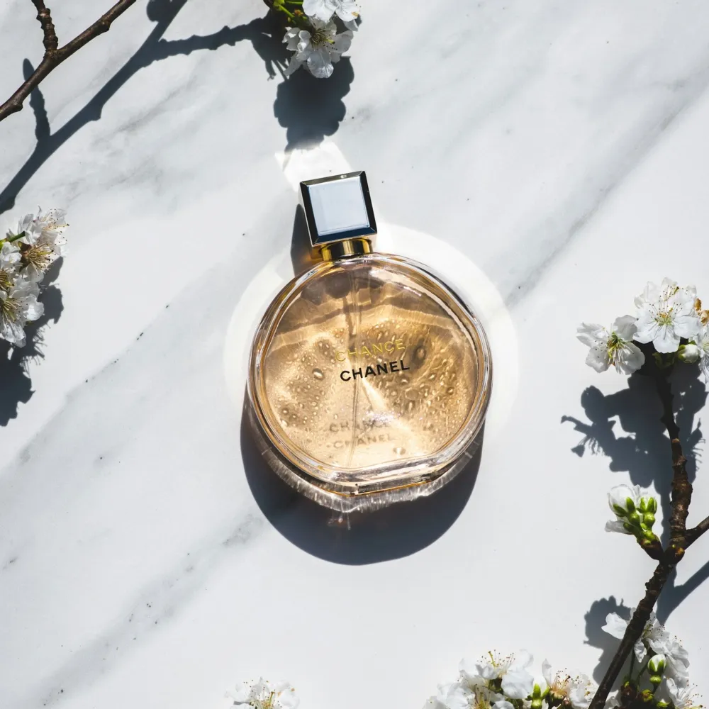 Perfume Surrounded by Flowers